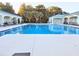 A serene community pool with lounge chairs offers a relaxing oasis for residents at 10975 Sw 69Th Cir, Ocala, FL 34476