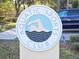 A sign displaying the Aquatic Sports Club logo, showing a swimmer in a pool, advertising the community's pool at 10975 Sw 69Th Cir, Ocala, FL 34476