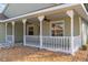 Covered front porch with white railings and ceiling fans at 10975 Sw 69Th Cir, Ocala, FL 34476