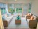 Bright sun room featuring wicker furniture, and lots of natural light at 10975 Sw 69Th Cir, Ocala, FL 34476