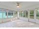 Spacious sunroom with tile floors and large windows offering scenic views at 10975 Sw 69Th Cir, Ocala, FL 34476