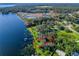 Aerial view of lakeside property with lush landscaping and private dock at 11754 Se 123Rd St, Belleview, FL 34420