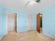 Bedroom with light blue walls, ceiling fan and double door closets at 11754 Se 123Rd St, Belleview, FL 34420