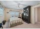 Bedroom with ceiling fan, window, and built-in storage at 11754 Se 123Rd St, Belleview, FL 34420