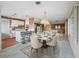 Modern dining room with white table and chairs near kitchen at 11754 Se 123Rd St, Belleview, FL 34420