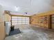 Attached garage with built-in shelving and laundry area at 11754 Se 123Rd St, Belleview, FL 34420