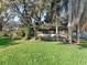 Charming house with a large deck, lush landscaping, and mature trees at 11754 Se 123Rd St, Belleview, FL 34420