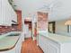 Kitchen with white cabinets and a view into another room at 11754 Se 123Rd St, Belleview, FL 34420