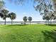 Peaceful lakefront view with palm trees and a dock at 11754 Se 123Rd St, Belleview, FL 34420