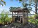 Wooden outdoor kitchen with pergola and grill at 11754 Se 123Rd St, Belleview, FL 34420