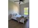 Light and airy bedroom featuring wood floors, a ceiling fan, and bright natural light from the window at 12205 Sw 71St Lane Rd, Ocala, FL 34481