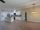 Open-concept kitchen featuring a large island, stainless steel appliances, and white cabinetry, seamlessly connected to the living area at 12205 Sw 71St Lane Rd, Ocala, FL 34481