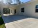 Spacious covered patio with an overhead fan and sliding glass doors, creating a seamless transition to the backyard and natural light at 12205 Sw 71St Lane Rd, Ocala, FL 34481