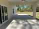 Covered patio area with a ceiling fan, offering a relaxing outdoor space with views of the backyard and surrounding greenery at 12205 Sw 71St Lane Rd, Ocala, FL 34481