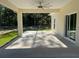 Relaxing covered patio with a ceiling fan, providing shade and comfort for outdoor enjoyment with nature views at 12205 Sw 71St Lane Rd, Ocala, FL 34481