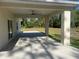 Inviting covered patio with a ceiling fan, perfect for outdoor relaxation and entertaining overlooking the serene backyard setting at 12205 Sw 71St Lane Rd, Ocala, FL 34481