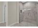 Modern bathroom with a glass-enclosed tiled shower featuring built-in shelving and contemporary fixtures at 12205 Sw 71St Lane Rd, Ocala, FL 34481