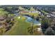 Scenic aerial view of a well-maintained golf course featuring lush green fairways, ponds, and sand bunkers at 17819 Sw 61St Lane Rd, Dunnellon, FL 34432