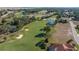Beautiful aerial shot showcasing a well-manicured golf course surrounded by trees, ponds, and residential properties at 17819 Sw 61St Lane Rd, Dunnellon, FL 34432