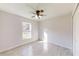 Well-lit bedroom with tile floors and a ceiling fan at 232 Locust Pass, Ocala, FL 34472