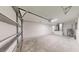 Clean and bright garage with whitewashed walls and an automatic door at 232 Locust Pass, Ocala, FL 34472