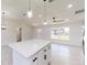 Modern kitchen island with white quartz countertop and black hardware at 232 Locust Pass, Ocala, FL 34472