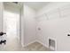 Bright laundry room with garage access and ample shelving at 232 Locust Pass, Ocala, FL 34472