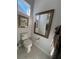 Clean bathroom with toilet, large mirror, and stylish decor at 3642 Nw 55Th Cir, Ocala, FL 34482