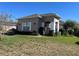 Tan house with white columns, landscaping, and a black fence at 3642 Nw 55Th Cir, Ocala, FL 34482