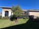 Backyard of tan house with a tree and black fence at 3642 Nw 55Th Cir, Ocala, FL 34482