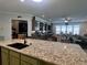 Kitchen with large island, granite countertops and view into Gathering room at 3642 Nw 55Th Cir, Ocala, FL 34482