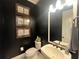 Elegant powder room with dark walls and pedestal sink at 3642 Nw 55Th Cir, Ocala, FL 34482