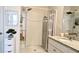 Bathroom with granite countertop, tiled shower, and white cabinetry at 547 Tanaro Ln, Haines City, FL 33844