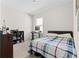 Well-lit bedroom with a window for natural light, a desk, and carpet flooring at 547 Tanaro Ln, Haines City, FL 33844