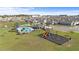 Aerial view of a community area with a pool, clubhouse, and playground in a Gathering-friendly neighborhood at 547 Tanaro Ln, Haines City, FL 33844