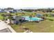 Overhead view of a community pool, featuring palm trees, lounge chairs, and a covered picnic area at 547 Tanaro Ln, Haines City, FL 33844