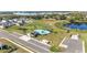 Aerial view showcasing a community pool, playground, and pond in a neighborhood with lake views at 547 Tanaro Ln, Haines City, FL 33844