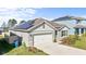 View of a single Gathering home featuring newly installed solar panels on the roof at 547 Tanaro Ln, Haines City, FL 33844