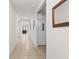 Bright hallway with neutral-colored tile flooring, leading to various rooms in the home at 547 Tanaro Ln, Haines City, FL 33844