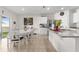 Bright kitchen with island seating, white cabinets, and an adjoining dining area at 547 Tanaro Ln, Haines City, FL 33844