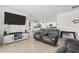 Open-concept living room with tile flooring showcases the adjoining kitchen and dining area at 547 Tanaro Ln, Haines City, FL 33844