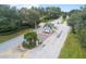 Aerial view of a gated entrance with mature trees and landscaping offering privacy and security at 10886 Sw 90Th Ter, Ocala, FL 34481