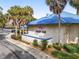 Charming exterior view of Orchid Club featuring a blue roof, stone facade, and well-maintained landscaping at 10886 Sw 90Th Ter, Ocala, FL 34481