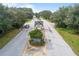 Aerial shot of gated entrance to neighborhood, featuring mature trees and a secure entry point at 10886 Sw 90Th Ter, Ocala, FL 34481