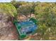 Aerial view of pickleball courts surrounded by lush greenery with players enjoying a game at 10886 Sw 90Th Ter, Ocala, FL 34481