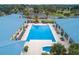 Aerial view of the pool area featuring lounge chairs and covered seating, perfect for relaxation and socializing at 10886 Sw 90Th Ter, Ocala, FL 34481