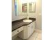 Bathroom featuring granite countertop and decorative white cabinetry at 11354 Sw 138Th Pl, Dunnellon, FL 34432