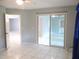 This bedroom features neutral walls, tile flooring, and sliding doors to the outdoor area at 11354 Sw 138Th Pl, Dunnellon, FL 34432