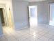 Bedroom with white tile flooring and large door at 11354 Sw 138Th Pl, Dunnellon, FL 34432