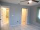 Bedroom featuring tile flooring, a ceiling fan, and doors leading to the bathroom and closet at 11354 Sw 138Th Pl, Dunnellon, FL 34432